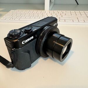Canon Black Digital Camera Compact Design with Protruding Lens